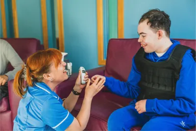 A nurse from St Piers smiling at a SENd student