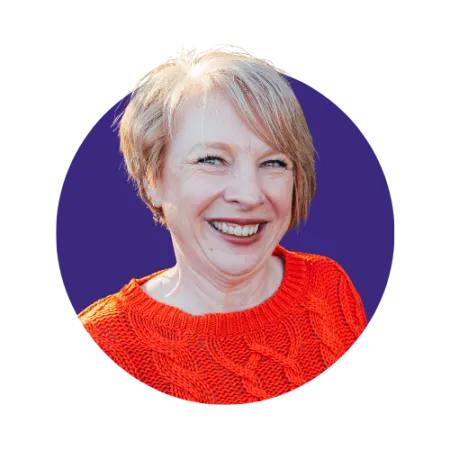 Short haired blonde woman smiling with a red top