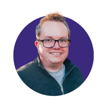 Short blonde haired man with glasses smiling