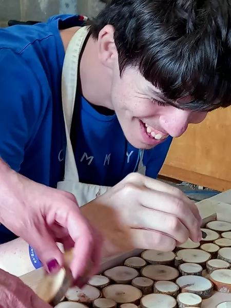 student smiling whilst blowing bubbles